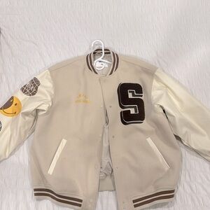 This is a beige, H&M letter men Jacket and cute patches on the sleeve